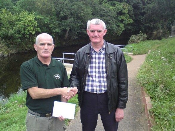 Tommy McGrath competition secretary of Moyola Angling Association presents a cheque for �1240 to John Barry of Cancer  Research UK Castledawson branch